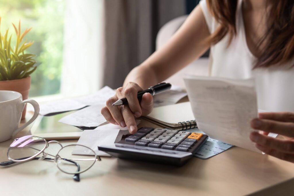 a women using a calculator for budgeting